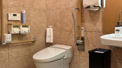 a bathroom with a toilet and a sink at Toyoko Inn Yokohama Tsurumi eki Higashi guchi in Yokohama