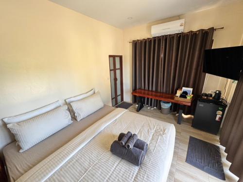 a bedroom with a bed with two bags on it at O Zen Resort in Ko Man Nai