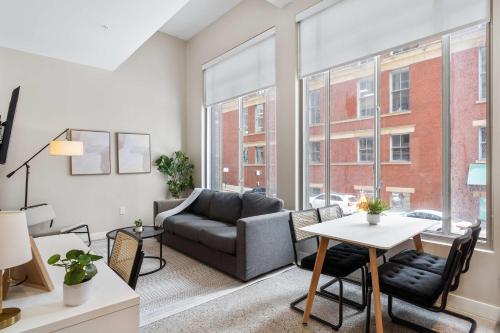 a living room with a couch and a table at CozySuites at Textile in Cincinnati