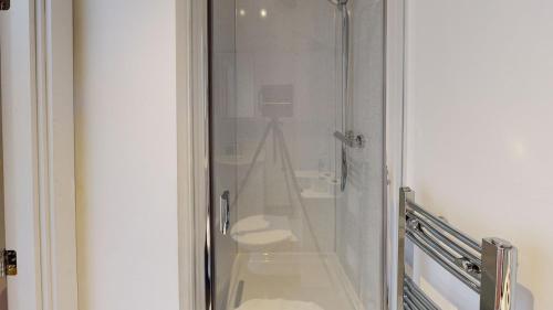a glass shower in a bathroom with a toilet at Corner View Studio Nottingham City Centre in Nottingham