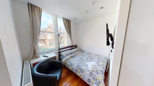 a small bedroom with a bed and a window at Corner View Studio Nottingham City Centre in Nottingham