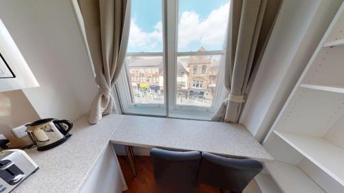a room with a counter and a large window at Corner View Studio Nottingham City Centre in Nottingham