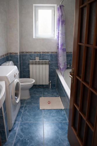 a bathroom with a toilet and a sink and a bath tub at ApartHotel EURO in Cahul