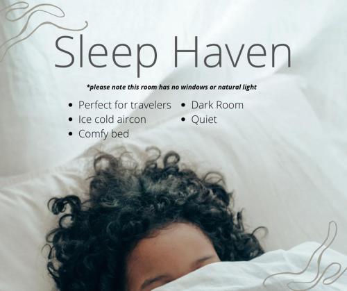 a woman laying in bed with curly hair at Kokos Hostel Padang City in Padang