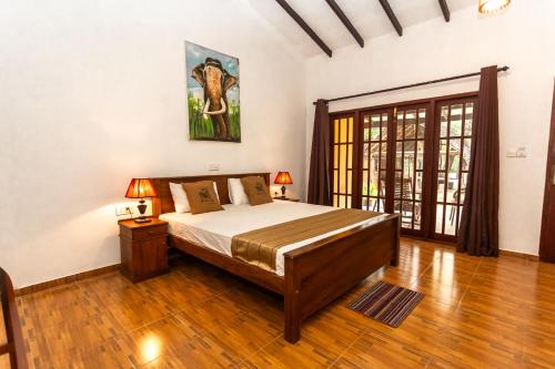a bedroom with a bed in a room at Elephant Path by Alpine Resorts in Habarana