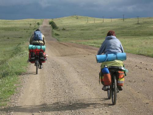 two people riding bikes on a dirt road at Xotel in Xanten