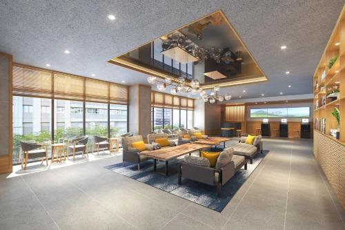 a large living room with a table and chairs at Via Inn Prime Kumamoto in Kumamoto