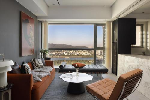 a living room with a couch and a table at ChangSha YunXi Riverview Hotel in Changsha