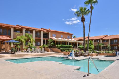 a resort with a swimming pool and palm trees at 3 Palms Tucson North Foothills in Tucson