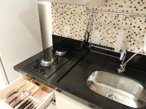 a kitchen with a sink and a stove at Life Resort in Brasília