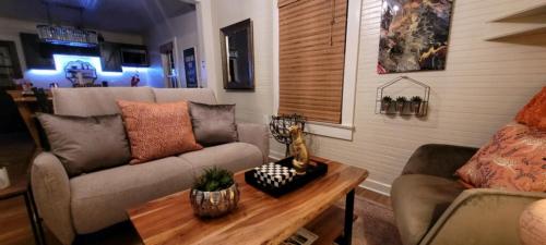 a living room with a couch and a table at Clemson Memorabilia House Frank Howard III Home in Clemson