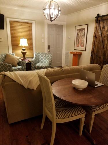 a living room with a couch and a table with a laptop at Clemson Memorabilia House Frank Howard III Home in Clemson