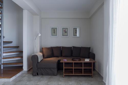 a living room with a couch and a table at Dialiskari Villas in Marathopolis