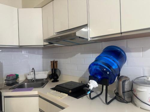 a blue blow dryer on a counter in a kitchen at Riala Suite Cebu in Sampong