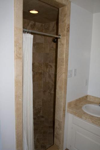 a bathroom with a shower with a shower curtain at Outer Banks Motel in Buxton