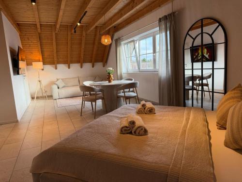 a bedroom with a bed and a table and chairs at Aparthotel Casa Vasco - by Willms & Schömer eG in Euskirchen