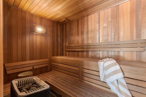 an empty wooden sauna with a basket in it at Picture Point Terraces in Noosa Heads
