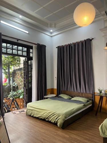 a bedroom with a bed and a window at Susu Homestay Hue in Thôn Kim Long (1)