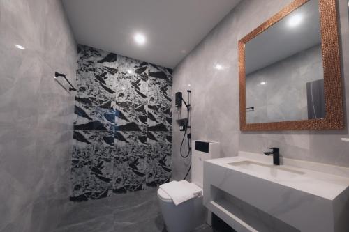 a bathroom with a sink and a mirror at LAFIN resort in Phetchabun