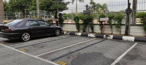 a black car parked in a parking lot at Izzafea Ampang KL in Ampang