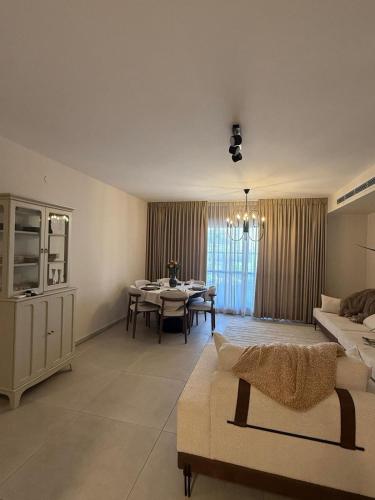 a living room with a table and a dining room at Shemesh Boutique in Beit Shemesh