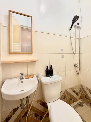 a bathroom with a toilet and a sink at Brisa Room T in El Nido Airport