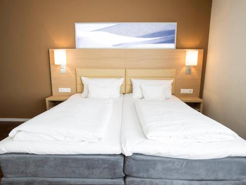 Ένα ή περισσότερα κρεβάτια σε δωμάτιο στο Bonnox Boardinghouse & Hotel