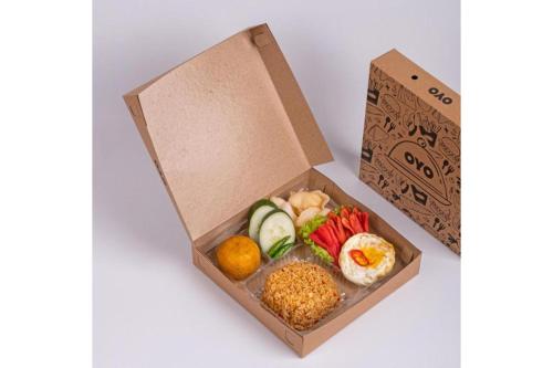 a box filled with different types of food at Hotel O M Authentic Kost Man in Padang
