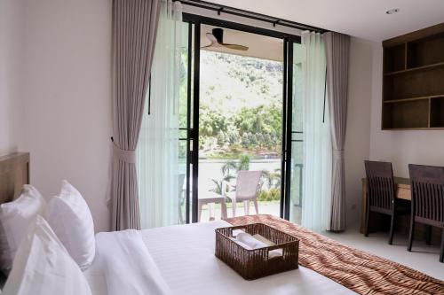 a bedroom with a bed with a basket on it at Tiger House River Kwai in Ban Tha Thong Mon