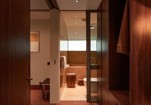 a view of a bathroom with a toilet and a tub at Brown Feather Pererenan in Canggu