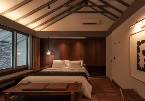 a bedroom with a large bed and a large window at Brown Feather Pererenan in Canggu