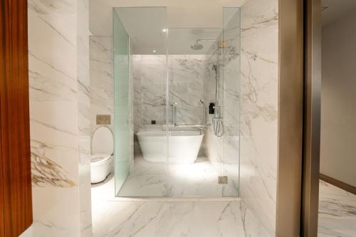 a bathroom with a tub and a toilet at St Giles Mid Valley Kuala Lumpur in Kuala Lumpur