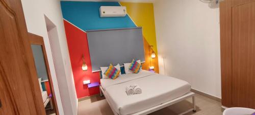 a small room with a bed in a room at goSTOPS Coorg in Madikeri