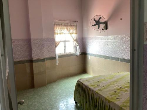 a room with a bed and a window in it at TuNo Homestay in Tuy Hoa