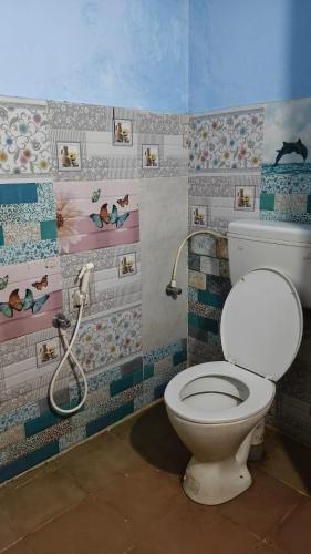 a bathroom with a toilet and a shower at Nature Retreat Stay in Pondicherry