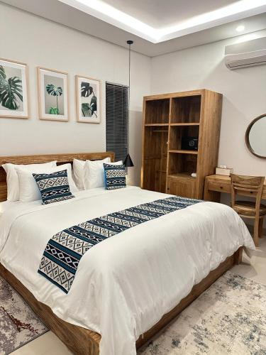 a bedroom with a large bed and a desk at Ngijeng Villa in Saba