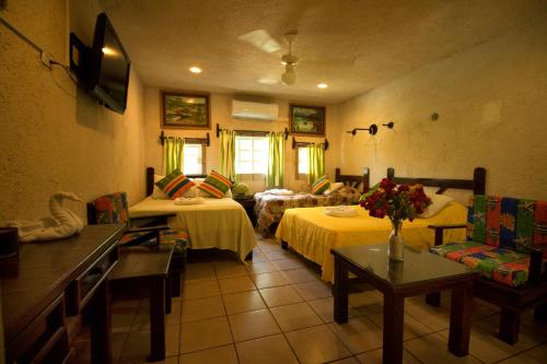 sala de estar con 2 camas y sofá en Hotel Sol Caribe en Isla Mujeres