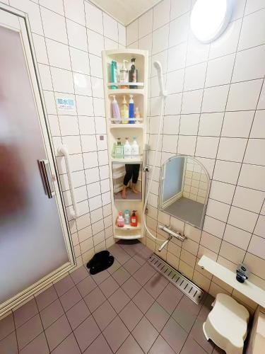 a bathroom with a toilet and a sink and a mirror at 烟雨轩 203 in Tokyo