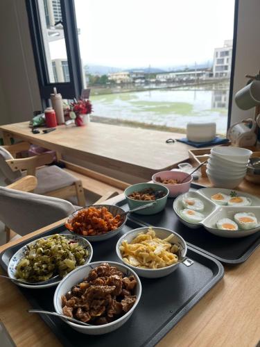 a table with a tray of different types of food at 5920 Elevator Guesthouse-5920電梯民宿 立案編號3020 in Wujie
