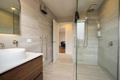 a bathroom with a sink and a shower at Murchison View house with Jacuzzi in Te Anau