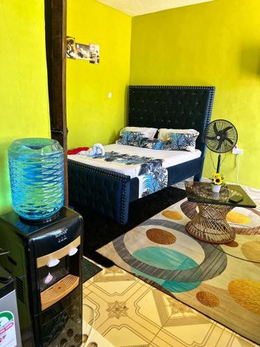 a bedroom with a bed and a table in a room at ADONAI homes in Malindi