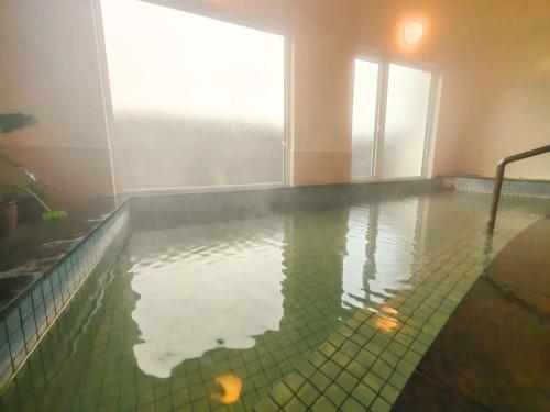 a swimming pool with water in a room at Hotel Sol at Lake Toya in Lake Toya