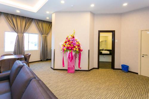 a lobby with a bunch of flowers in a room at Icon Hotel Segamat in Segamat