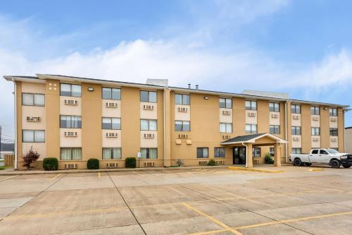 an apartment building with a parking lot at Super 8 by Wyndham Evansville East in Evansville