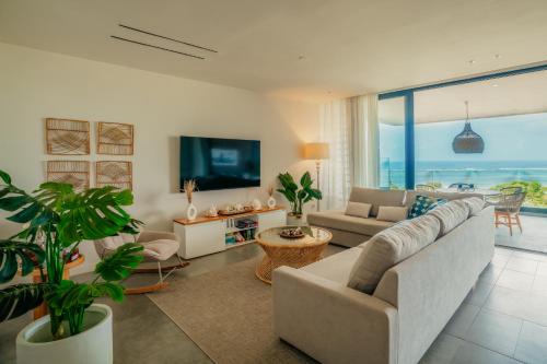 a living room with a couch and a tv at The View Mauritius in Ruisseau Créole