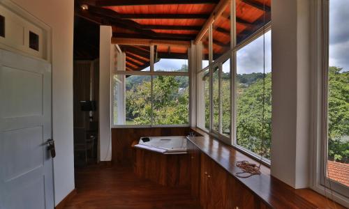 a bathroom with a sink and a large window at Viyana Boutique Hotel in Kandy