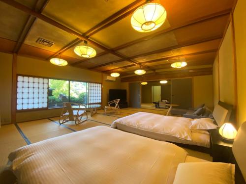 a bedroom with two beds in a room with lights at Wakamatsu HakoneYugawara in Yugawara