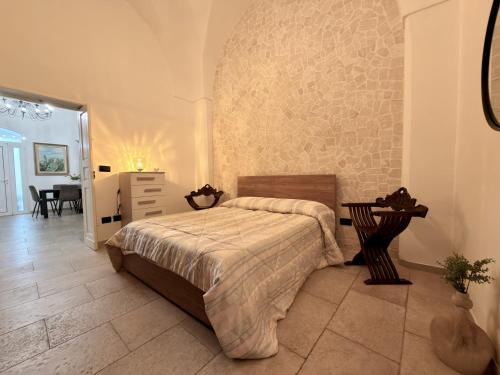 a bedroom with a bed and a table in it at Dimora Imperiali in Francavilla Fontana