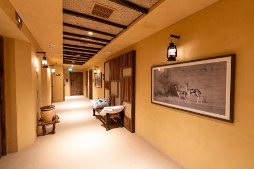 a hallway with a picture of a deer on the wall at The Luxe Retreat Hotel Apartments in Dubai