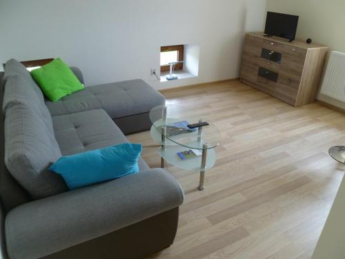 a living room with a couch and a glass table at Energy House in Jasło